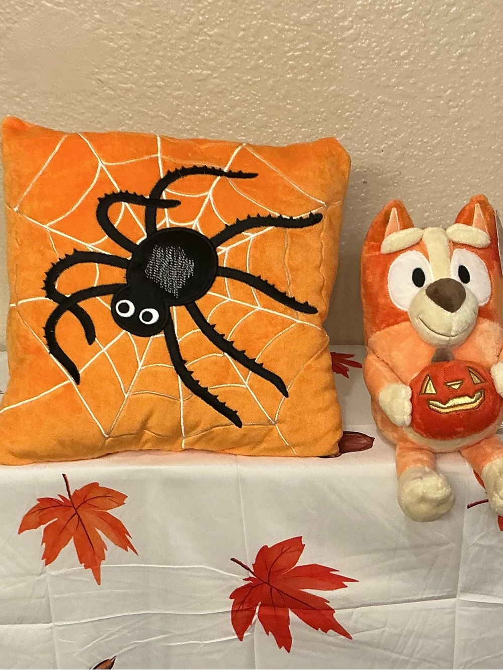 Bluey Plush Holding a Pumpkin and Orange Spider Web Pillow